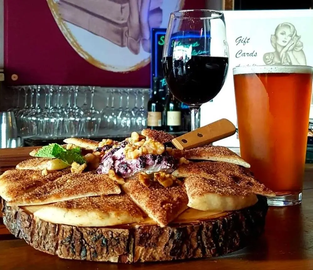 Baked brie with wine and craft beer during aperitivi hour