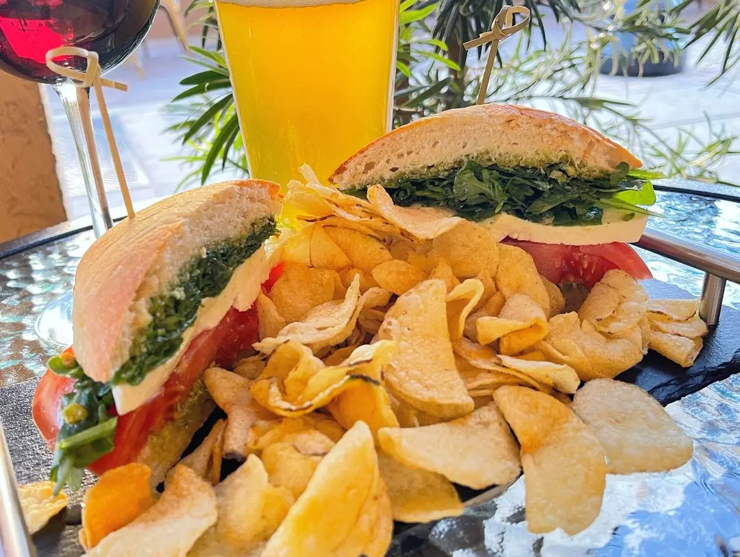 Caprese Panino with mozzarella, tomato, basil pesto and greens on ciabatta