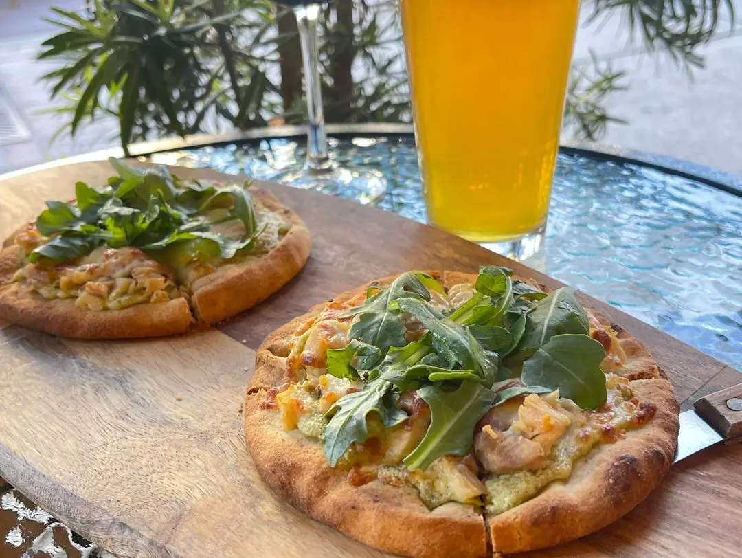 Chicken Piadina flatbread with grilled chicken, basil pesto, ricotta, mozzarella and greens