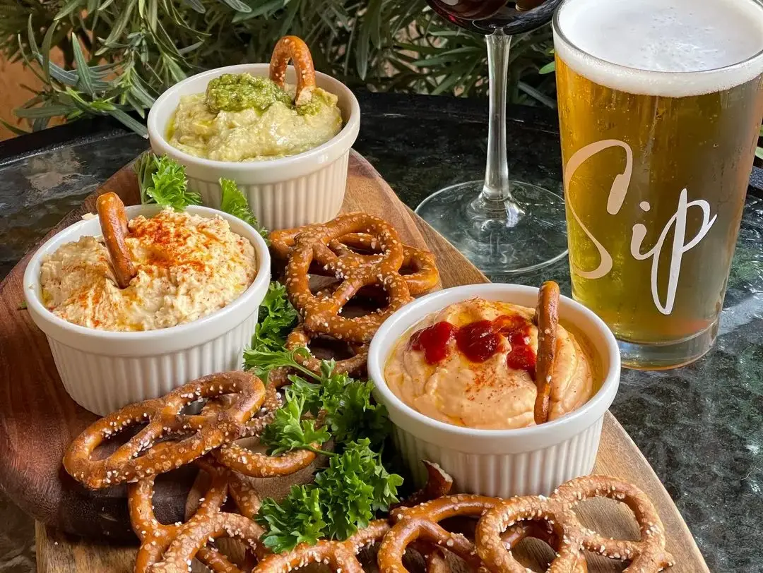 Hummus and sourdough pretzels in traditional, basil pesto and buffalo flavors