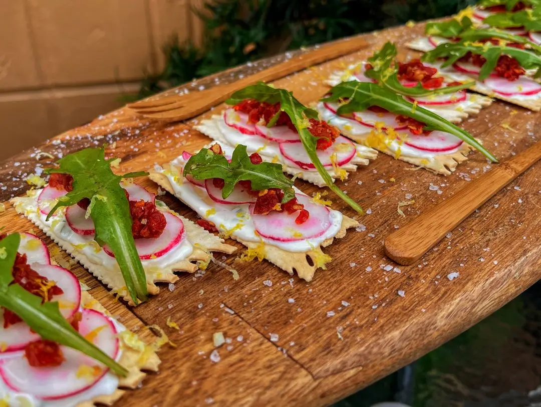 Mascarpone Croccantini with flatbread crackers, chived mascarpone, sun-dried tomatoes, radish and greens