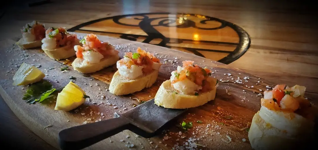 Shrimp Salsa Fresca on baguette with tomato, onion, cilantro and jalapeno